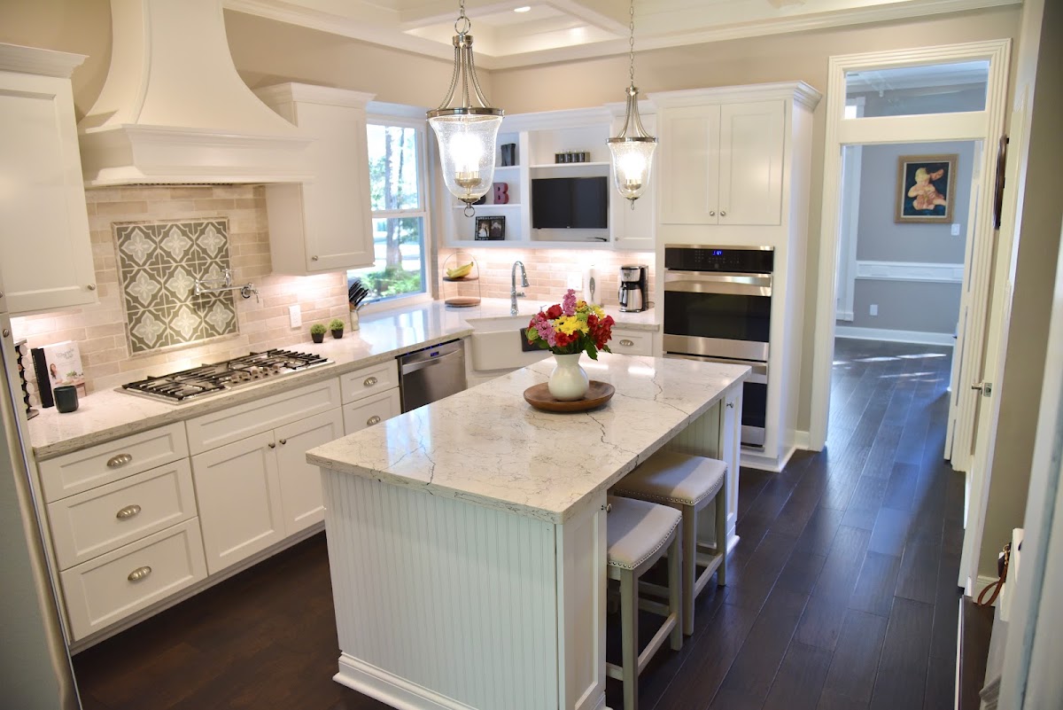 White kitchen remodel with marble island and pendant lighting