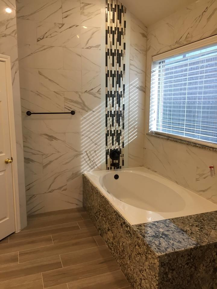 Bathroom remodel with marble tile and granite surround