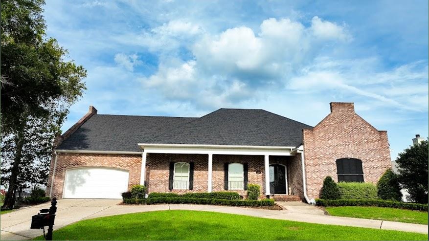 Completed roof on brick home in Tomball
