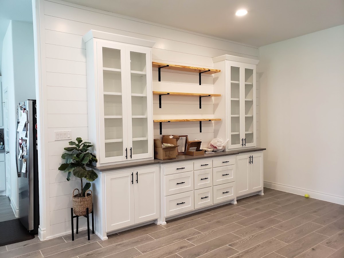 Custom built-in cabinetry with iron bracket shelves by Iron Grain