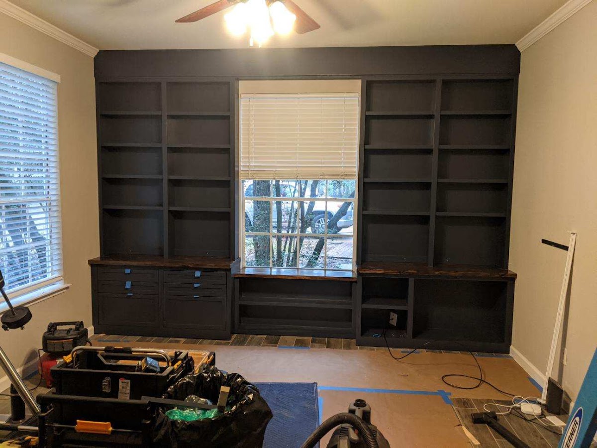 Dark painted floor-to-ceiling built-in bookcase