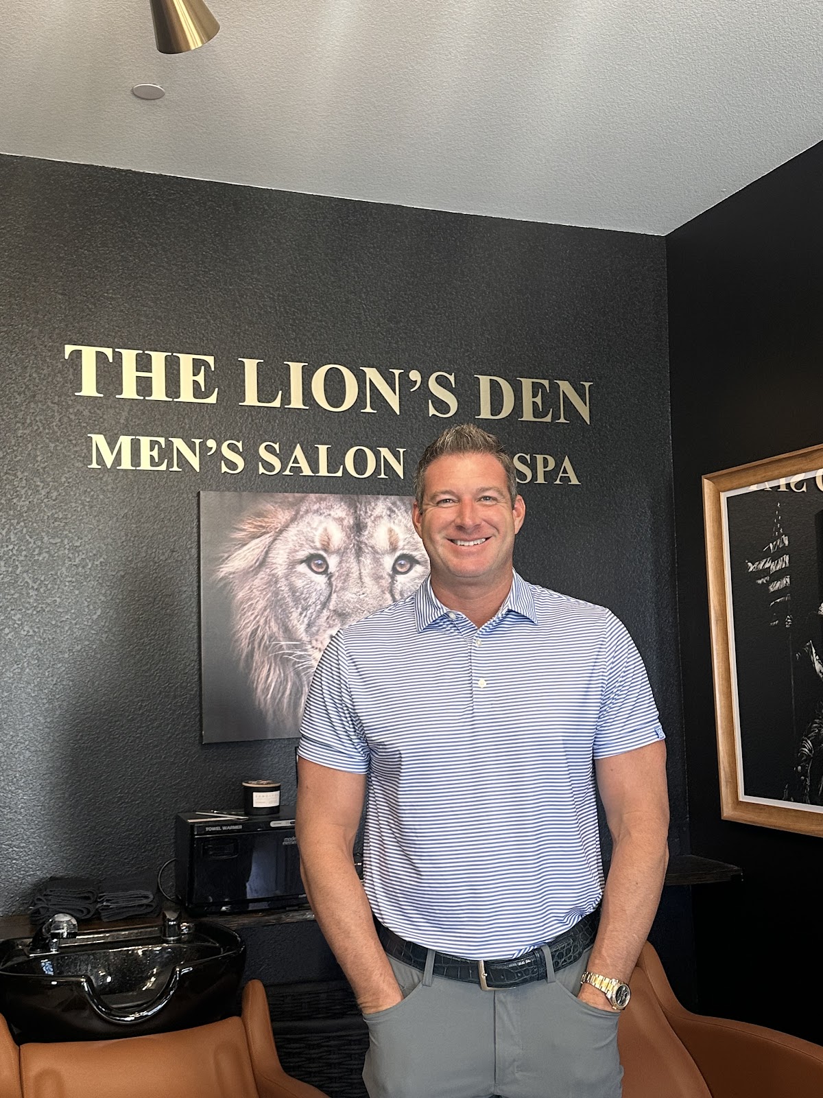 A client smiling in the salon after his haircut