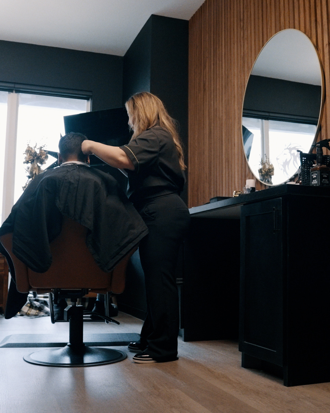 Blanca cutting hair at her station, showing her at work